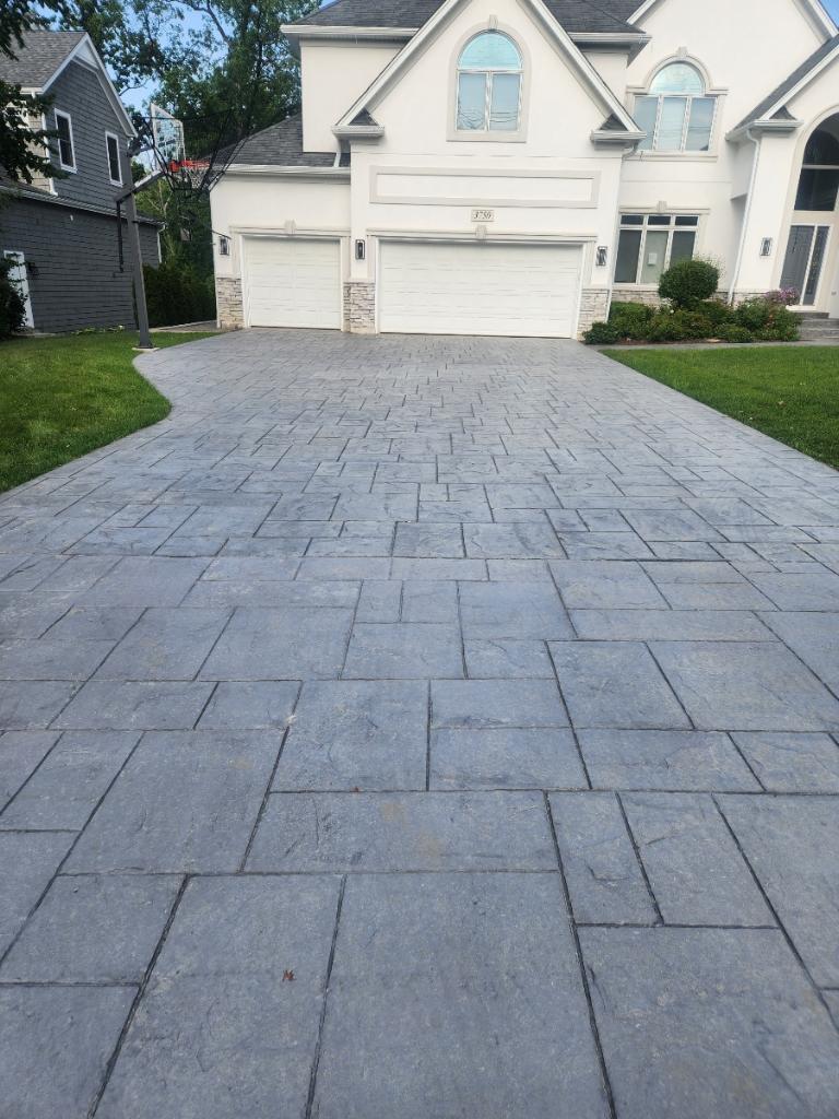 Large finished stamped concrete driveway at an upscale home