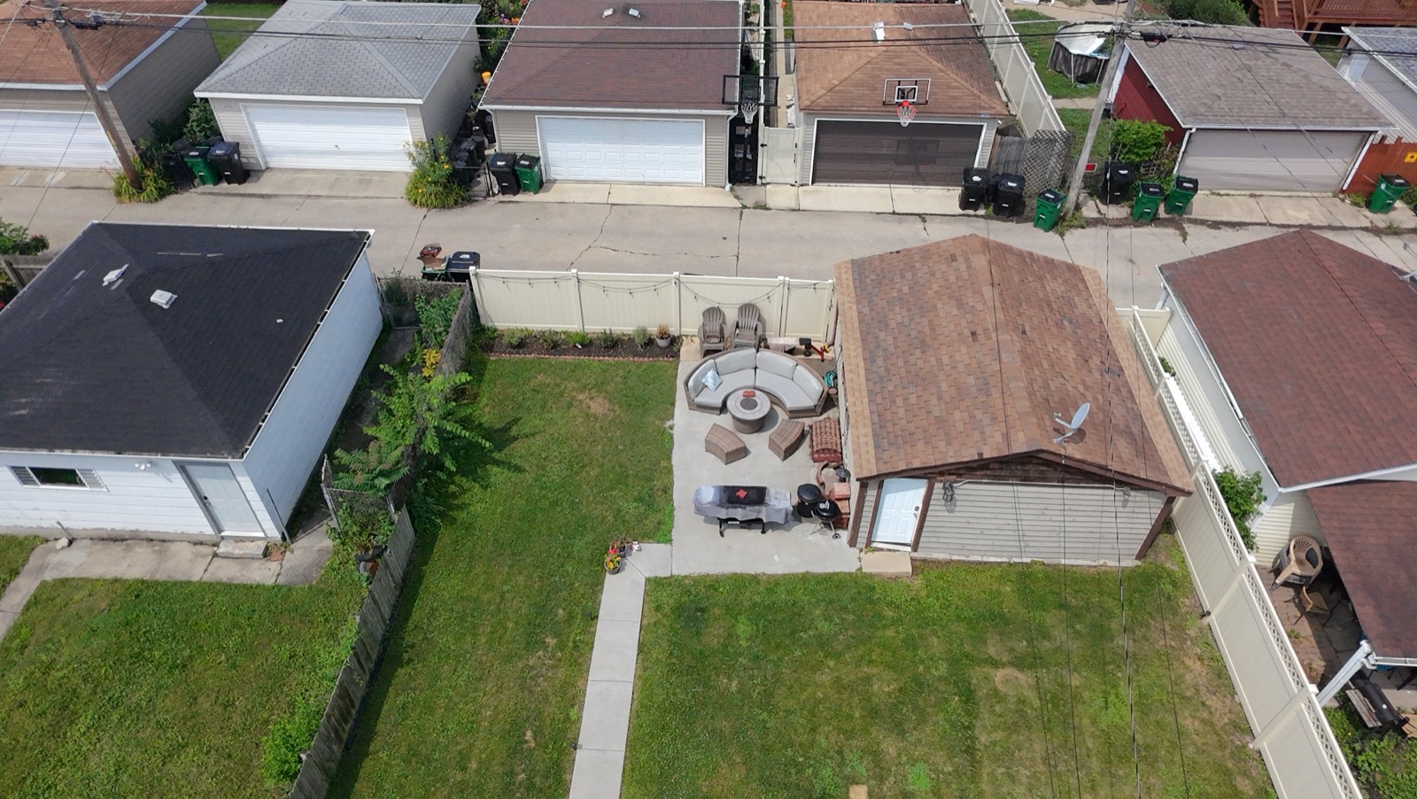 Aerial view of a finished backyard stamped concrete patio with gazebo and seating area