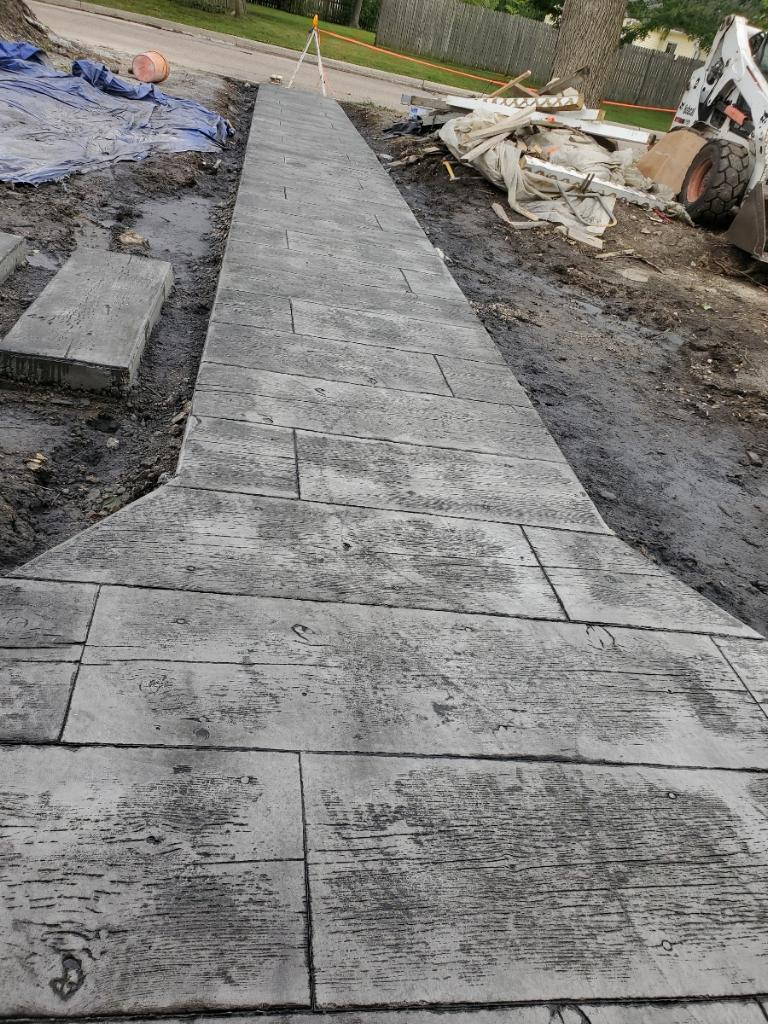 Stamped concrete walkway finished in a wood-plank pattern